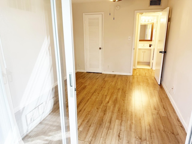 empty room with light hardwood / wood-style flooring