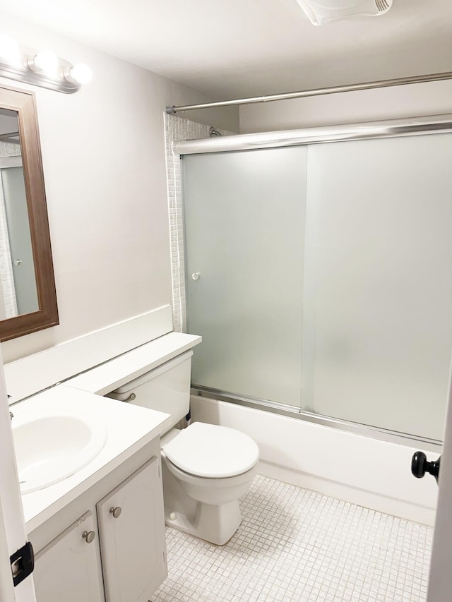 full bathroom with tile patterned flooring, vanity, toilet, and enclosed tub / shower combo