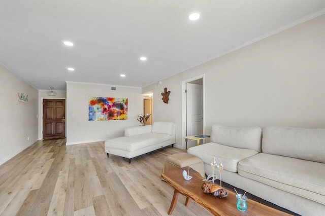 living room featuring light wood-type flooring and ornamental molding