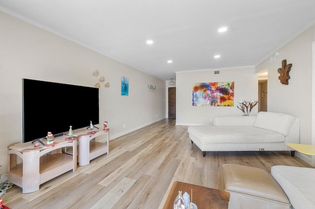 living room with crown molding and light hardwood / wood-style flooring