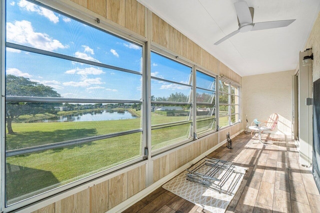 sunroom / solarium featuring ceiling fan and a water view