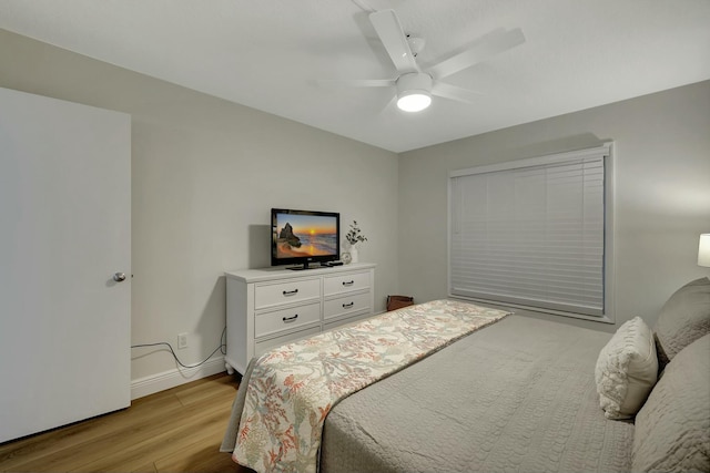 bedroom with ceiling fan and light hardwood / wood-style floors