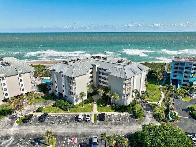 bird's eye view featuring a view of the beach and a water view