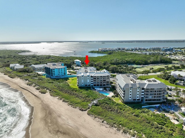 bird's eye view featuring a water view and a view of the beach