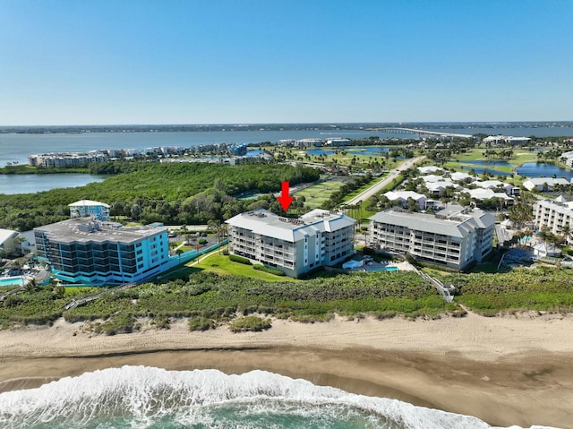 birds eye view of property featuring a view of the beach and a water view