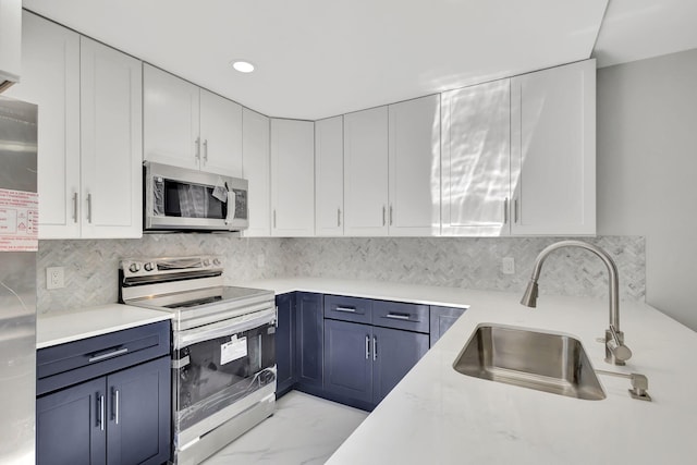 kitchen featuring blue cabinetry, white cabinetry, sink, and appliances with stainless steel finishes