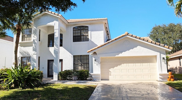 mediterranean / spanish-style house featuring a front yard and a garage