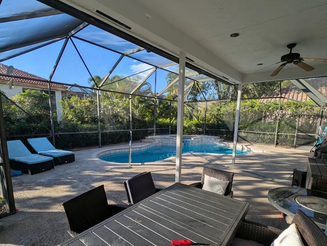 view of swimming pool featuring a lanai, a patio area, and ceiling fan