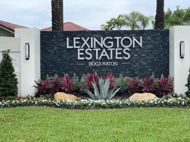 community / neighborhood sign with a lawn