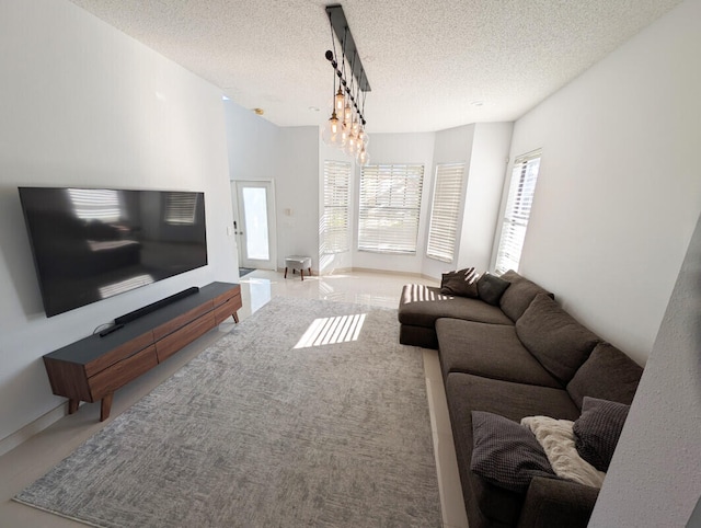 living room with a notable chandelier and a textured ceiling