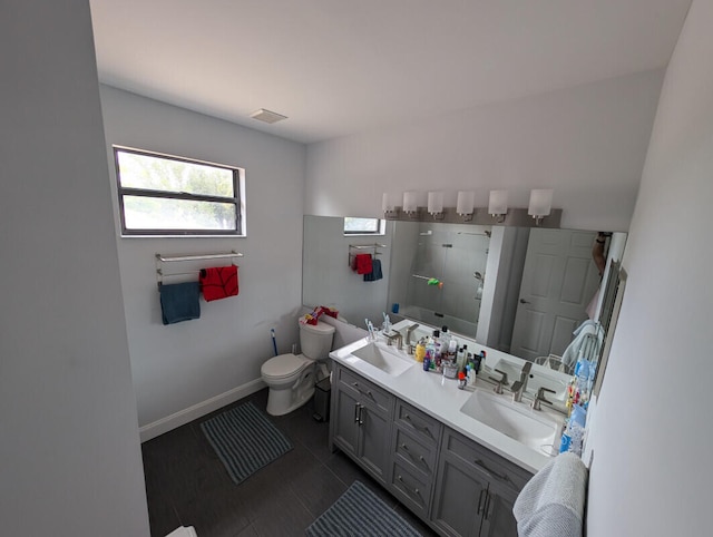 bathroom featuring vanity, toilet, and a shower