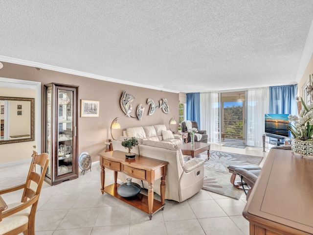 living area featuring light tile patterned floors, baseboards, ornamental molding, and a textured ceiling