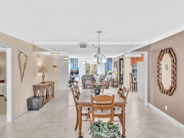 dining area with a textured ceiling, crown molding, a notable chandelier, and light tile patterned flooring