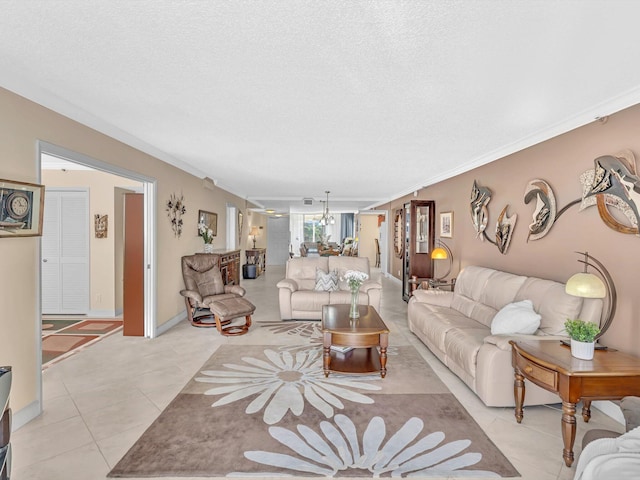 living room featuring light tile patterned flooring, ornamental molding, and a textured ceiling