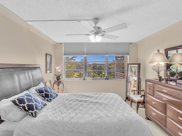 bedroom with carpet, ceiling fan, crown molding, and a textured ceiling