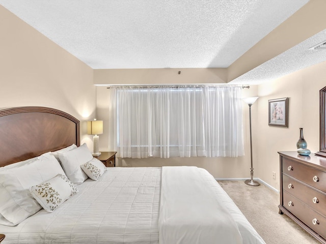 carpeted bedroom featuring a textured ceiling