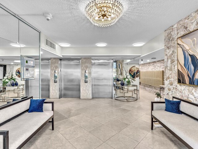 corridor with light tile patterned floors and a textured ceiling