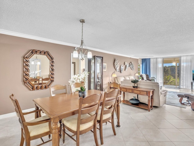 dining room with a textured ceiling, light tile patterned floors, a chandelier, and crown molding