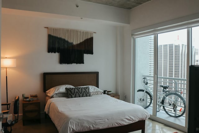 bedroom featuring access to exterior and wood-type flooring