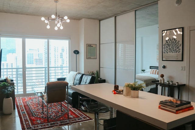 dining area featuring concrete floors and a chandelier