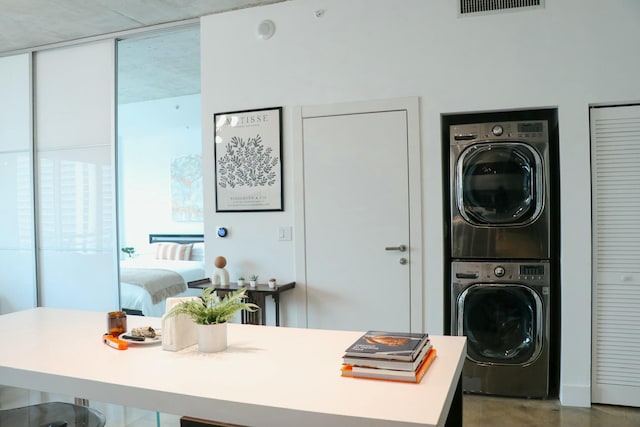 washroom featuring stacked washer and dryer