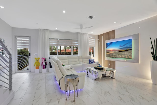 living room with ceiling fan and plenty of natural light