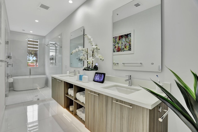 bathroom featuring tile patterned floors, vanity, and shower with separate bathtub