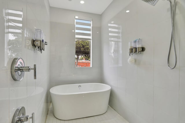 bathroom with tile patterned flooring, tile walls, and independent shower and bath