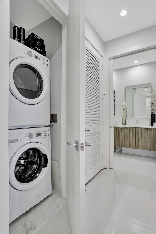 laundry room with stacked washer / drying machine