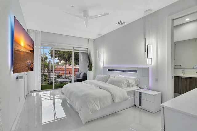 bedroom with ceiling fan, light tile patterned flooring, access to exterior, and ensuite bath