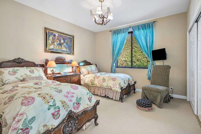 bedroom featuring carpet flooring, a closet, and a notable chandelier