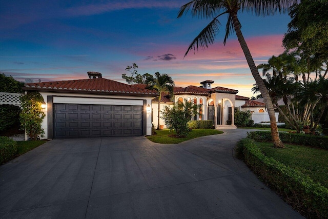 mediterranean / spanish home featuring a garage