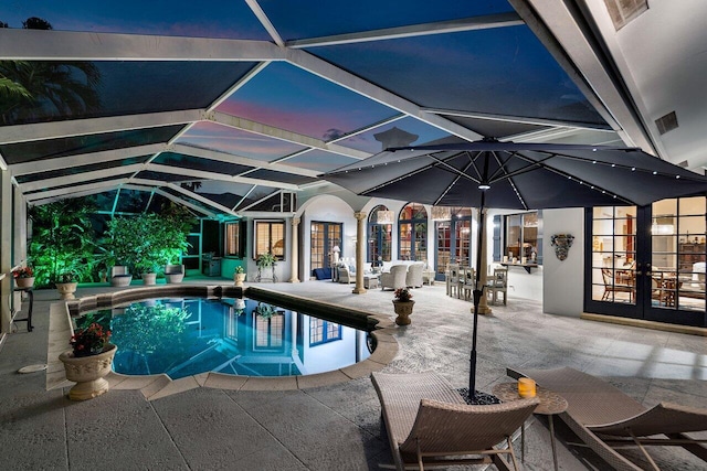 view of swimming pool with a patio area, french doors, and glass enclosure