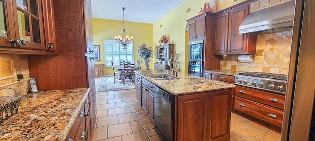 kitchen featuring sink, ventilation hood, an island with sink, stainless steel gas stovetop, and decorative backsplash