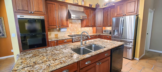 kitchen featuring black appliances, wall chimney range hood, sink, decorative backsplash, and light stone counters