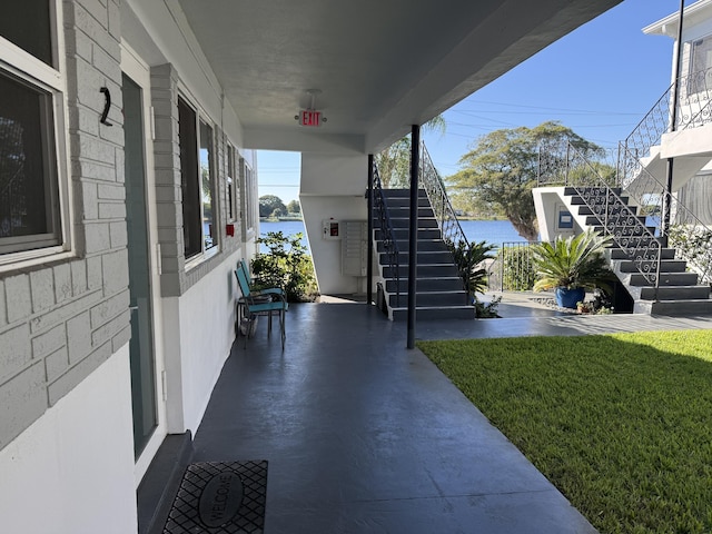 view of patio / terrace with covered porch and a water view