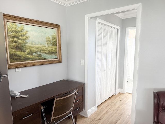 office with crown molding and light hardwood / wood-style flooring