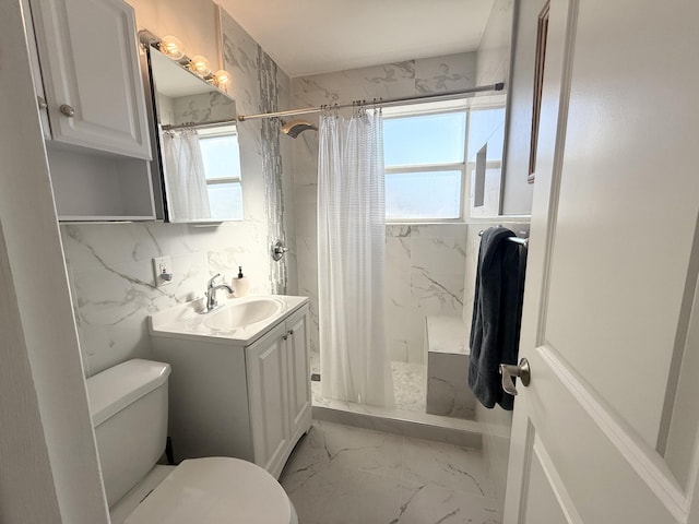 bathroom with toilet, vanity, and a shower with shower curtain