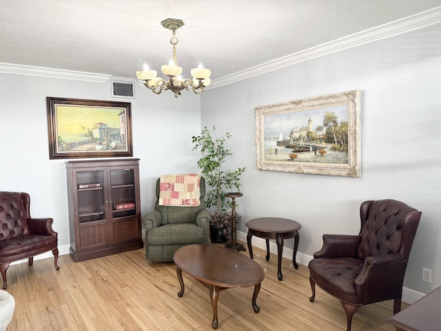 living area with an inviting chandelier, light hardwood / wood-style flooring, and crown molding