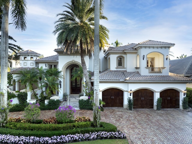 mediterranean / spanish-style home with a balcony and a garage