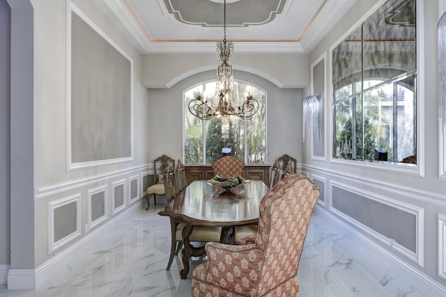 dining space featuring crown molding and a chandelier