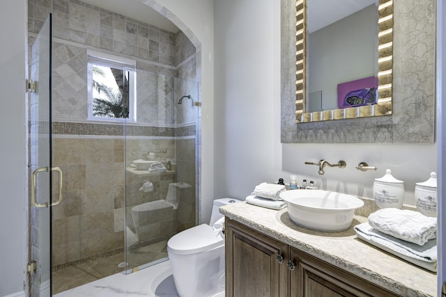 bathroom with walk in shower, vanity, and toilet