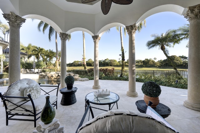 view of patio / terrace with ceiling fan and a water view