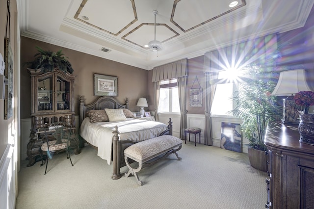 bedroom featuring carpet, a tray ceiling, ceiling fan, and crown molding