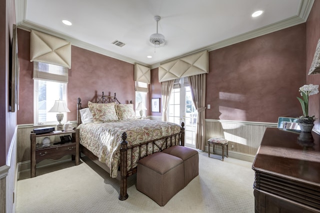 bedroom with light colored carpet, ceiling fan, and crown molding