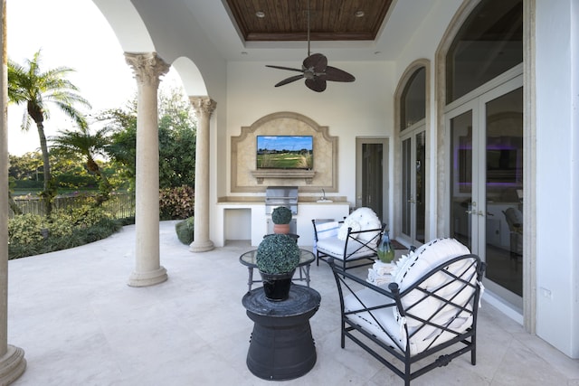 view of patio / terrace with ceiling fan, french doors, and an outdoor kitchen