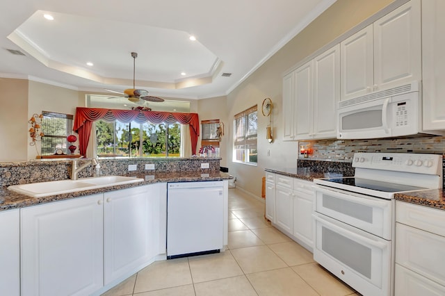 kitchen featuring white cabinetry, dark stone countertops, white appliances, and sink