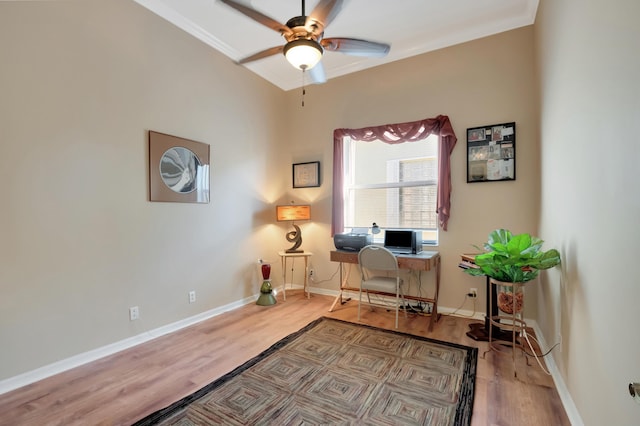 office area featuring light wood-type flooring, ceiling fan, and crown molding