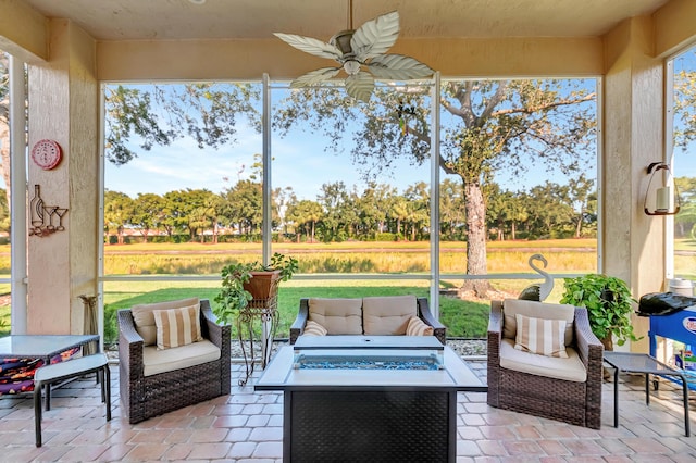 sunroom / solarium featuring ceiling fan