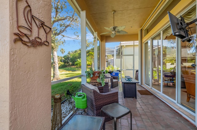 sunroom featuring ceiling fan